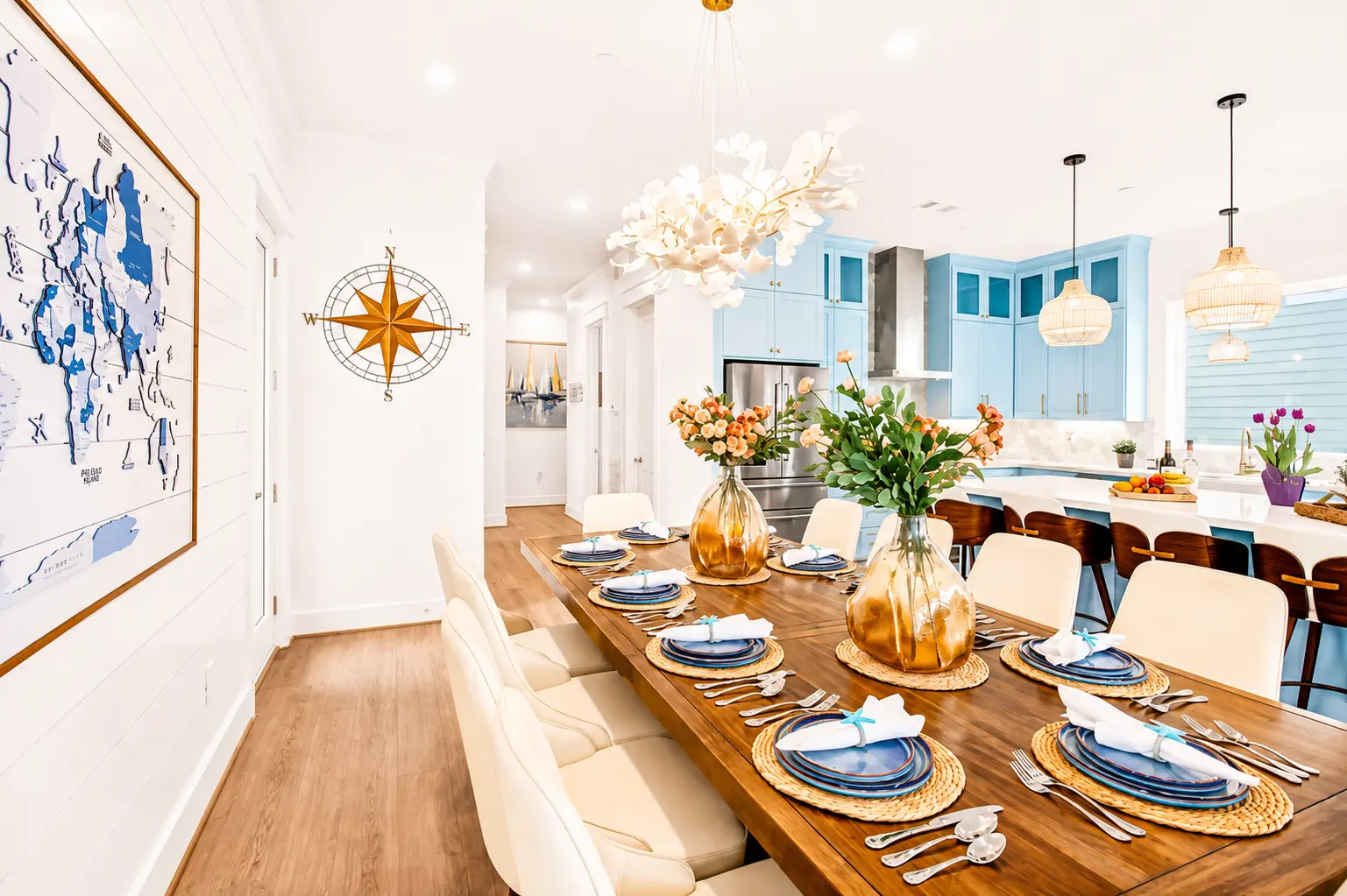 Dining table set beneath a coastal chandelier