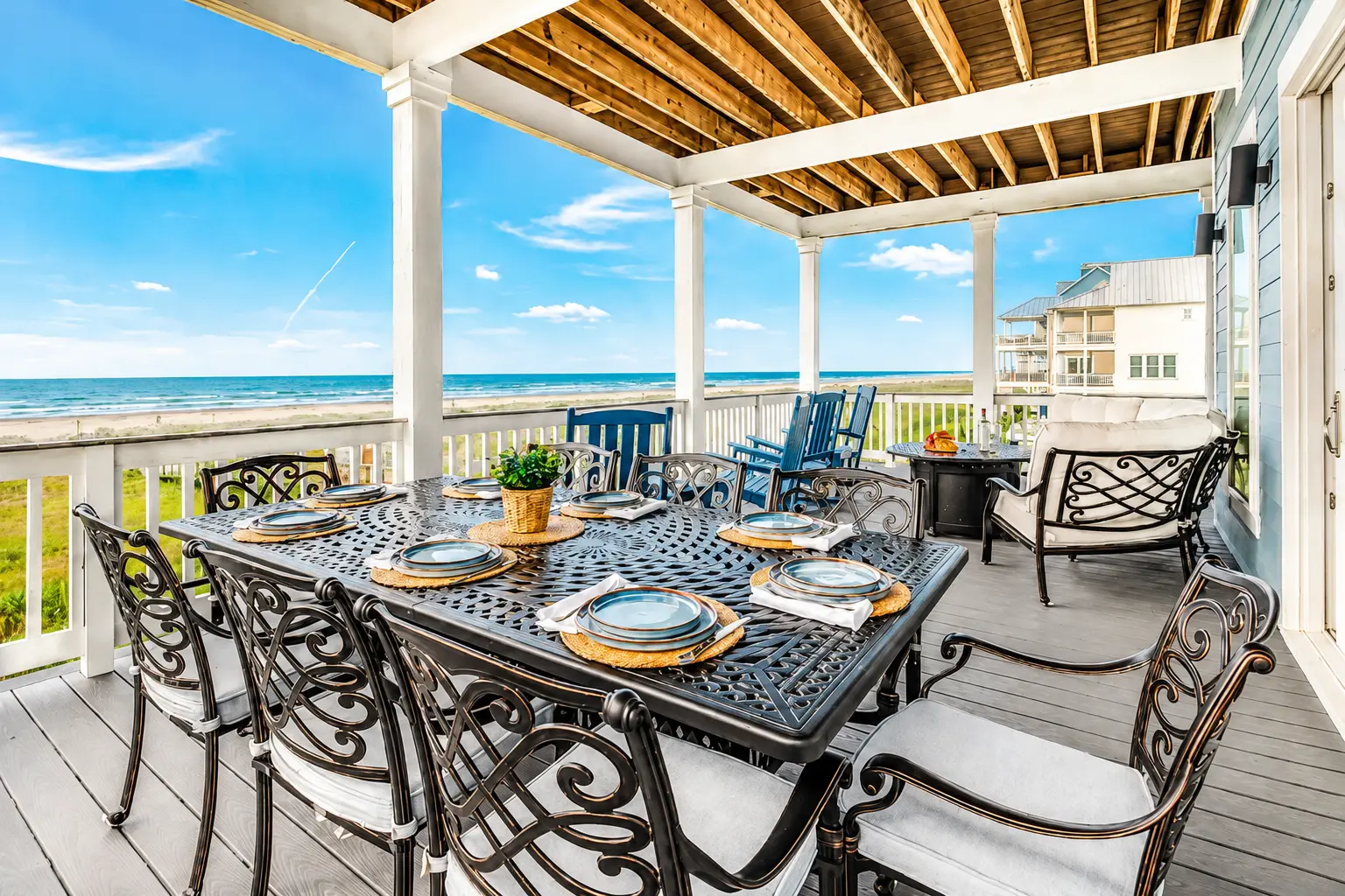 Porch dining with Gulf views at Grand Beach Retreat